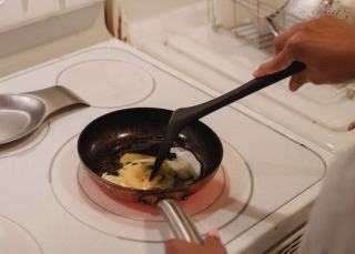 Fond de poêle en inox déglacé au vin blanc, spatule en bois